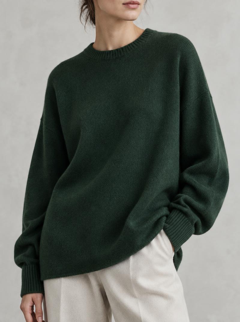 Forest green knit jumper styled against chalk architecture